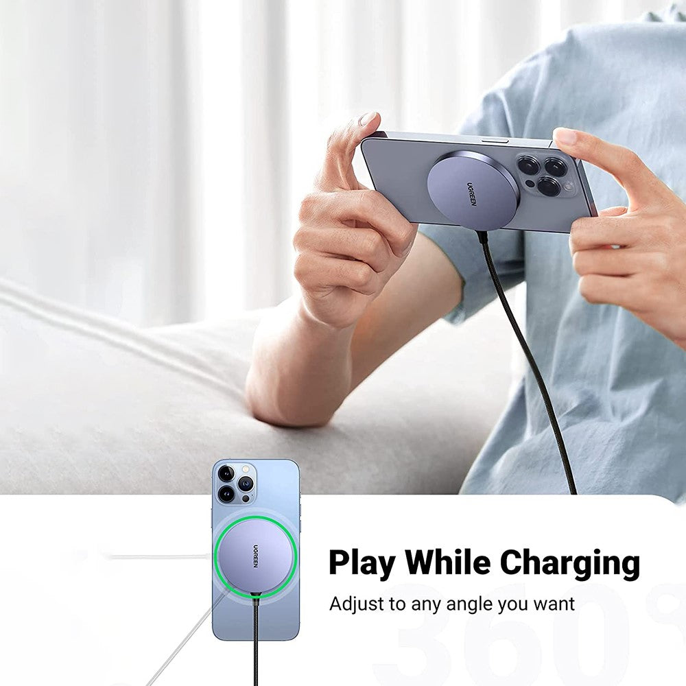 Ugreen 30233 charger attached to the back of an iPhone held in landscape while gaming, cable trailing