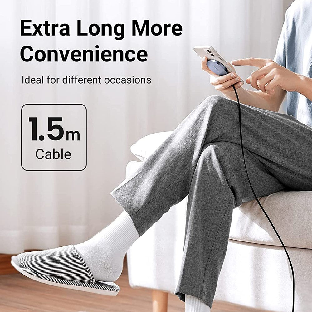 Ugreen 30233 charger attached to an iPhone in one hand, showing the 1.5m cable reaching from a sofa